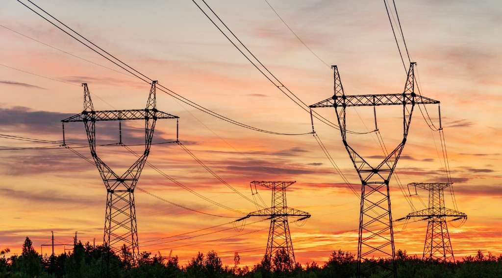 Transmission lines in front of sunset